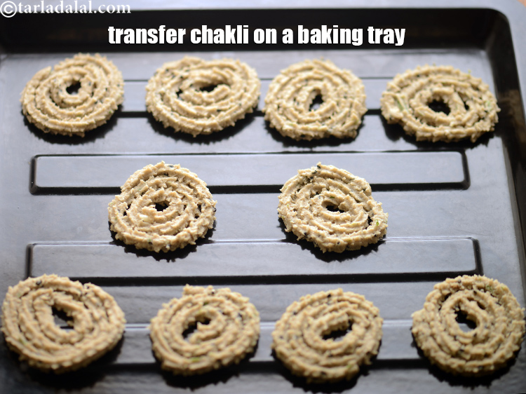 Step 34 – Place all the chaklis on a baking tray. Use a flat ladle as shown in …