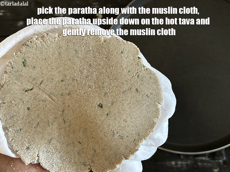 Step 21 – Pick the paratha along with the muslin cloth, place the paratha upside down on the …