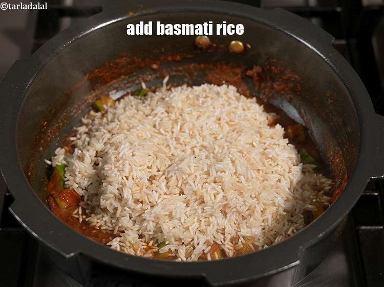 Step 21 – Add 1&frac14; cups <a href="https://www.tarladalal.com/glossary-long-grain-rice-basmati-chawal-basmati-rice-535i">long grain rice (basmati chawal)</a>&nbsp;<a href="https://www.tarladalal.com/glossary-rice-chawal-533i">rice (chawal)</a>&nbsp;, washed and drained.