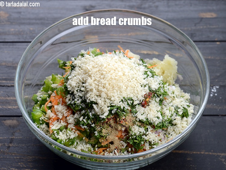 Step 22 – Add &frac14; cup <a href="https://www.tarladalal.com/glossary-bread-crumbs-breadcrumbs-222i">bread crumbs</a>.