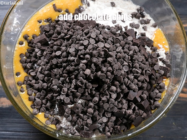 Step 21 – Add &frac34; cup <a href="https://www.tarladalal.com/glossary-chocolate-chips-325i">chocolate chips</a>.