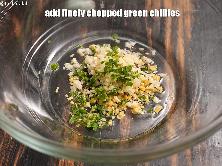 Step 21 – Add 1 tsp finely <a href="https://www.tarladalal.com/glossary-chopped-green-chilli-820i">chopped green chillies</a>.&nbsp;