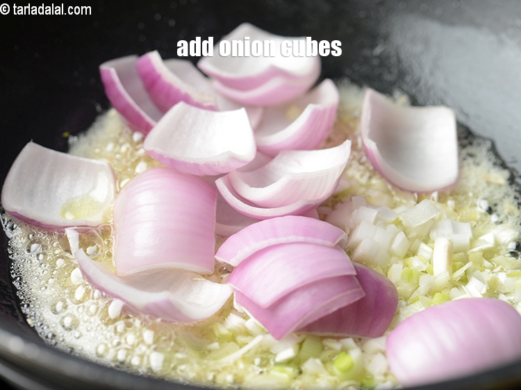 Step 22 – Add &frac12; cup <a href="https://www.tarladalal.com/glossary-onion-cubes-732i">onion cubes</a>.