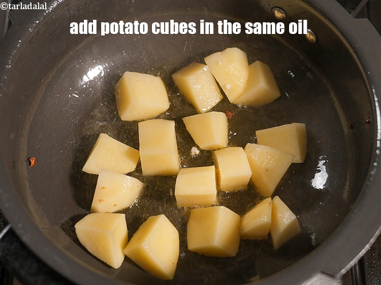 Step 21 – Add 1 cup <a href="https://www.tarladalal.com/glossary-potato-cubes-725i">potato cubes</a> in the same oil.