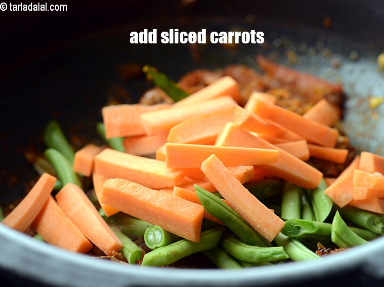 Step 21 – Add &frac12; cup <a href="https://www.tarladalal.com/glossary-sliced-carrots-748i">sliced carrots</a>.