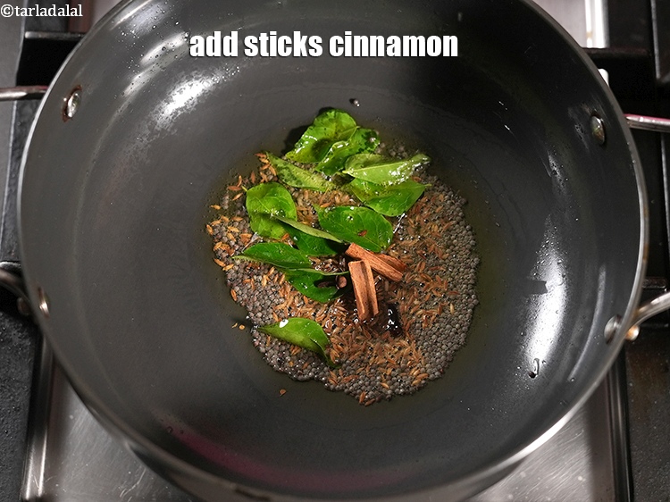 Step 21 – Add 2 sticks <a href="https://www.tarladalal.com/glossary-cinnamon-dalchini-346i">cinnamon (dalchini)</a>.
