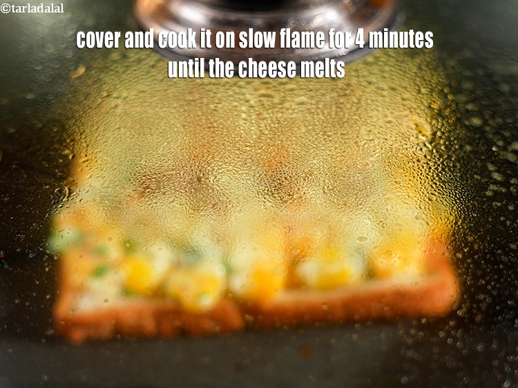 Step 21 – Cover and cook it on slow flame for 4 minutes until the cheese melts.