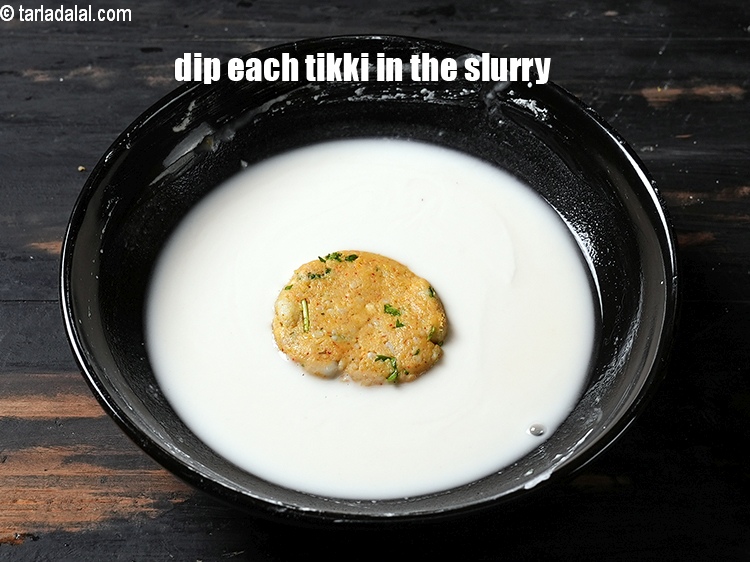 Step 21 – Dip each tikki in the cornflour slurry.