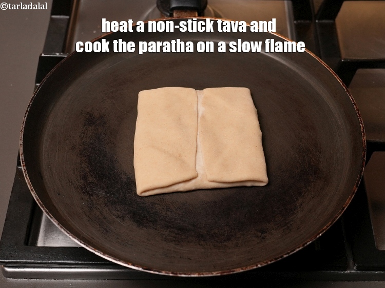 Step 29 – Heat a non-stick tava (griddle) and cook the paratha on a slow flame
