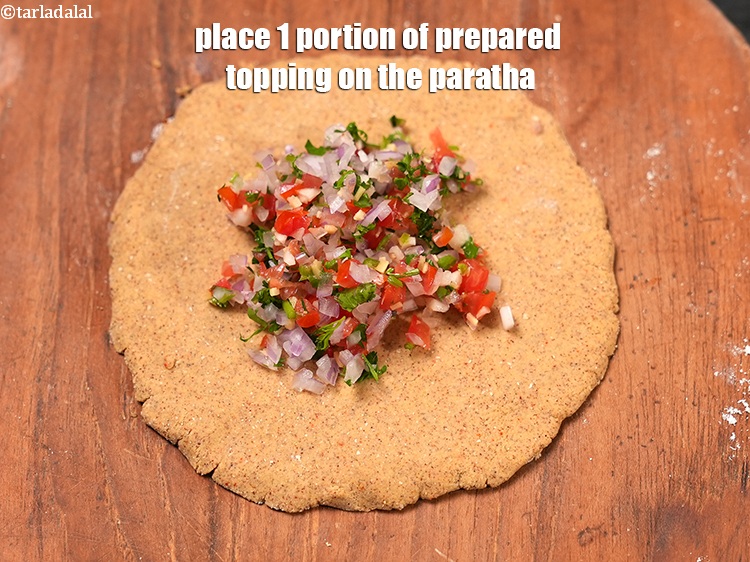 Step 22 – Place 1 portion of prepared topping on the paratha.