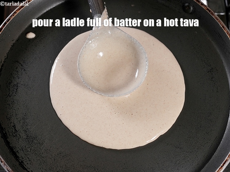 Step 22 – Pour a ladle full of batter on a hot tava.&nbsp;