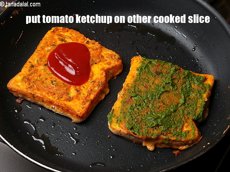 Step 22 – Put 1 tbsp <a href="https://www.tarladalal.com/glossary-tomato-ketchup-tomato-sauce-181i">tomato ketchup</a> on other cooked besan bread slice.