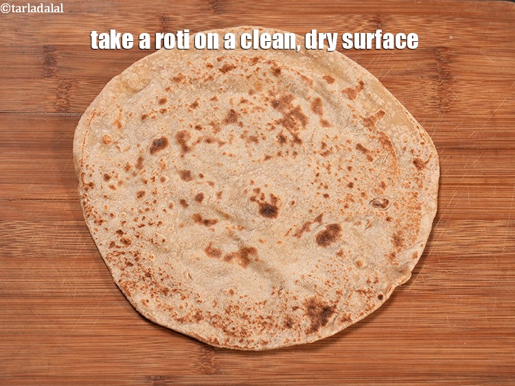 Step 21 – Take a <a href="https://www.tarladalal.com/rotis-7608r">roti</a>&nbsp;on a clean, dry surface.