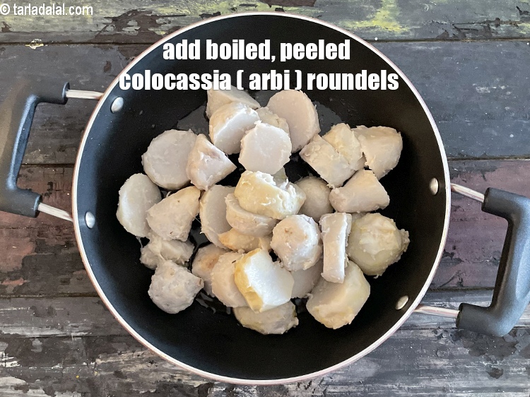 Step 23 – Add&nbsp;<meta charset="UTF-8" />2 1/2 cups&nbsp;boiled , peeled&nbsp;<a href="glossary-colocasia-arbi-arbi-root-taro-360i">colocasia (arbi)</a>&nbsp;thick roundels.
