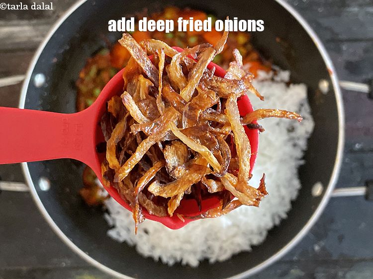 Step 21 – Add&nbsp;<meta charset="UTF-8" />1/2 cup&nbsp;<a href="glossary-fried-onions-924i">deep-fried onions</a>.