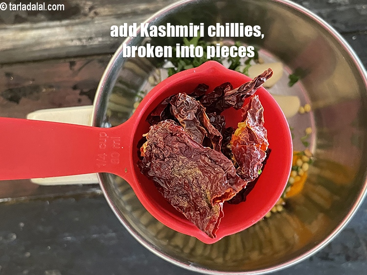 Step 21 – Add&nbsp;<meta charset="UTF-8" />4&nbsp;<a href="glossary-whole-dry-kashmiri-red-chillies-kashmiri-mirch-kashmiri-lal-mirch-332i">whole dry kashmiri red chillies</a>&nbsp;, broken into pieces.