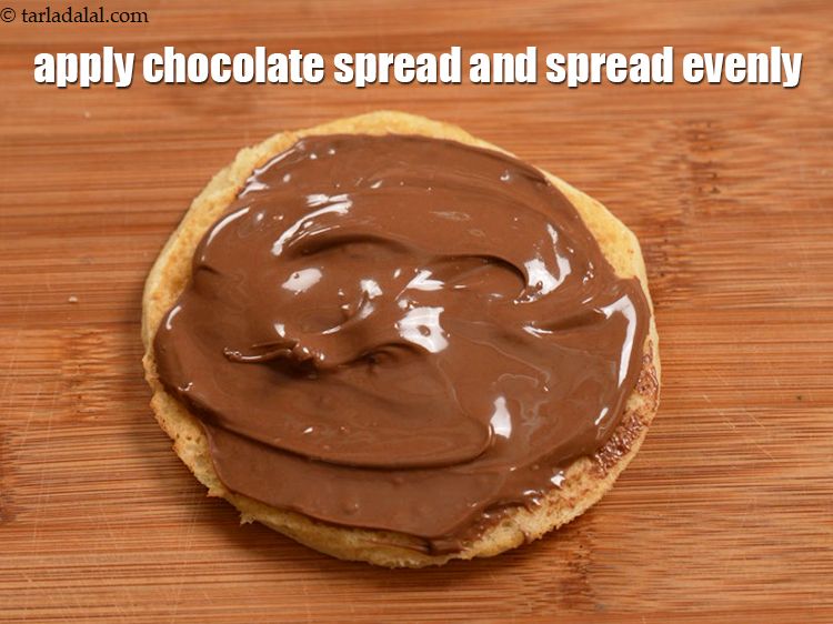 Step 21 – Apply 1 tbsp of chocolate spread and spread evenly over it.