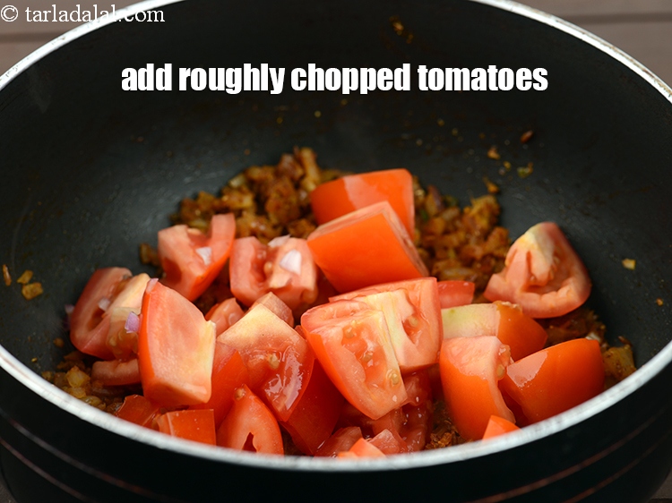 Step 26 – Add 1 cup&nbsp;roughly&nbsp;<a href="https://www.tarladalal.com/glossary-chopped-tomatoes-779i">chopped tomatoes</a>.