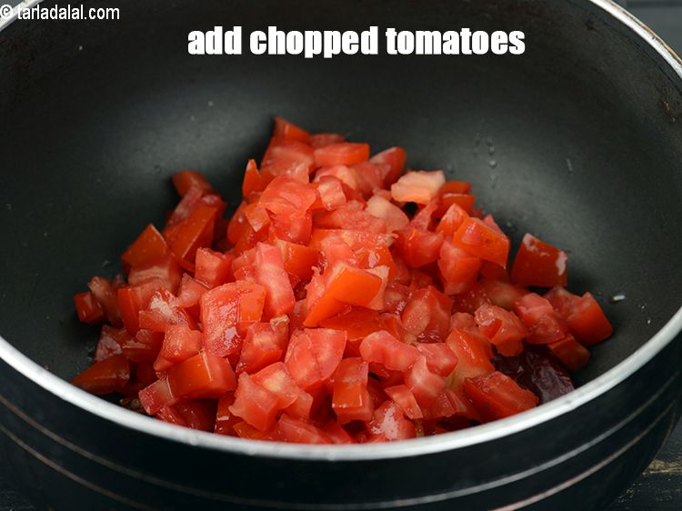 Step 21 – Add 1 cup <a href="https://www.tarladalal.com/glossary-chopped-tomatoes-779i">chopped tomatoes</a>.