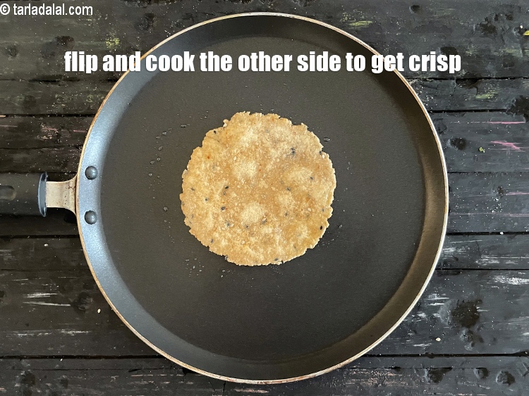 Step 21 – <meta charset="UTF-8" />Flip and cook the&nbsp;<strong>Khakhra</strong>&nbsp;on the other side. Cook on slow flame to get …