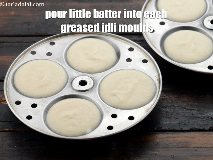 Step 25 – Pour spoonfuls of batter into each of the greased idli moulds.