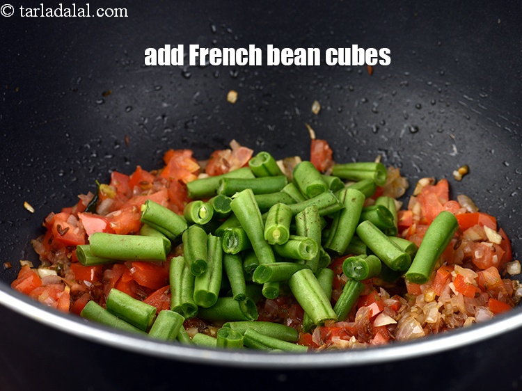 Step 22 – Add &frac12; cup <a href="https://www.tarladalal.com/glossary-french-bean-cubes-729i">french bean cubes</a>.