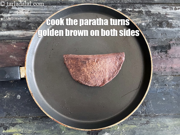 Step 26 – Cook the paratha, using a little oil, till it turns golden brown in colour from …