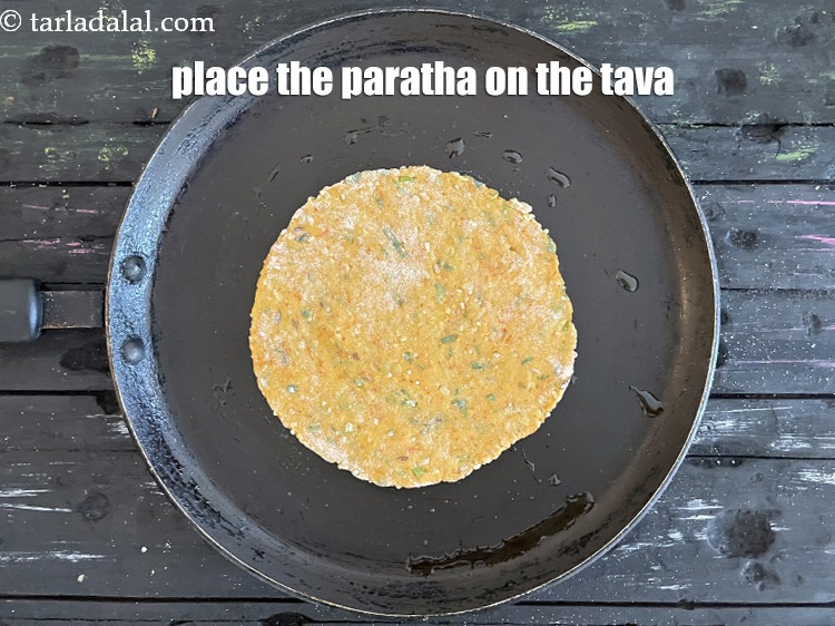 Step 22 – Place the paratha on a greased hot non-stick tava (griddle).