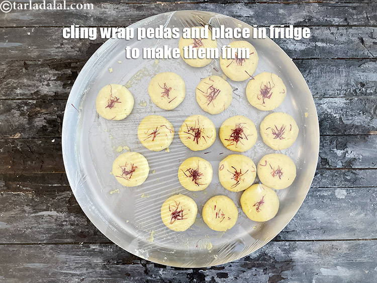 Step 29 – <meta charset="UTF-8" />Cover with a cling wrap.&nbsp;Refrigerate the&nbsp;<strong>Kesar Peda</strong>&nbsp;mixture for 30 minutes. This makes the …