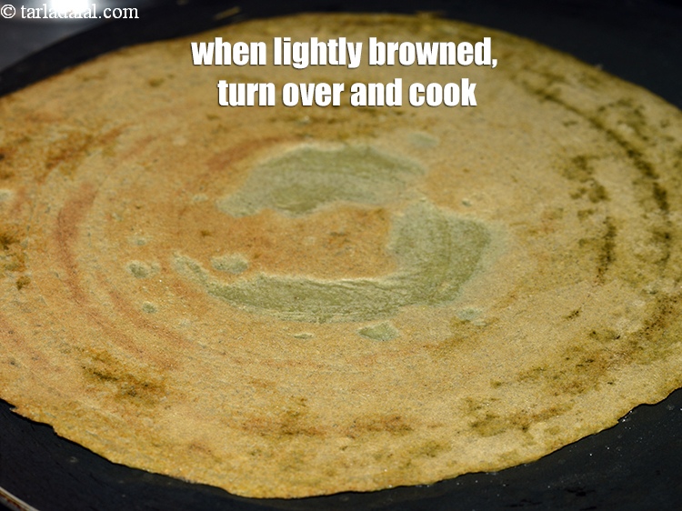 Step 21 – When the lower side of the pesarattu is lightly browned, turn it over and cook …