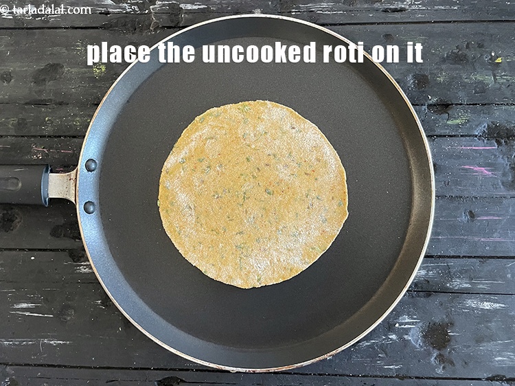 Step 21 – Place the uncooked roti on it.
