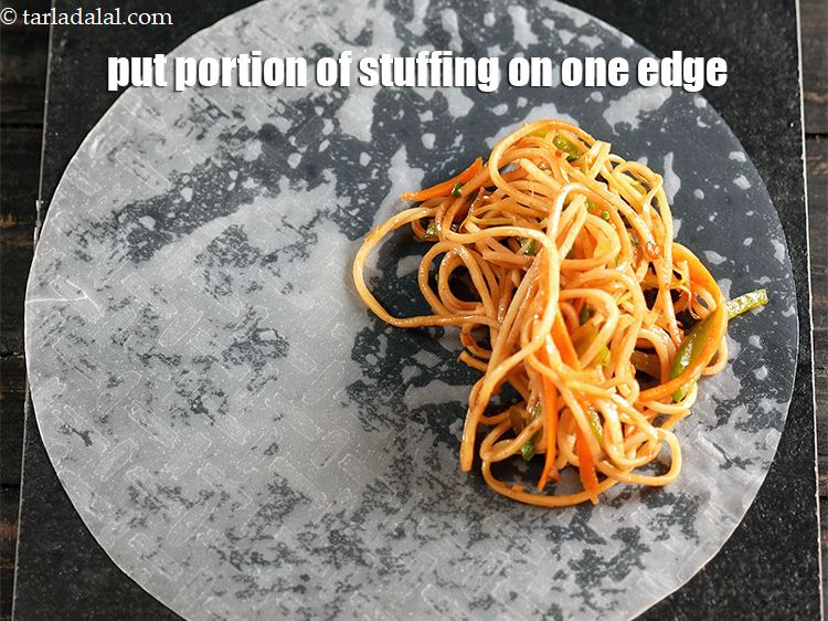 Step 22 – Put a portion of the stuffing on one edge of the wrapper.