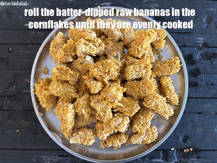Step 21 – Roll the batter-dipped raw bananas in the cornflakes until they are evenly coated.