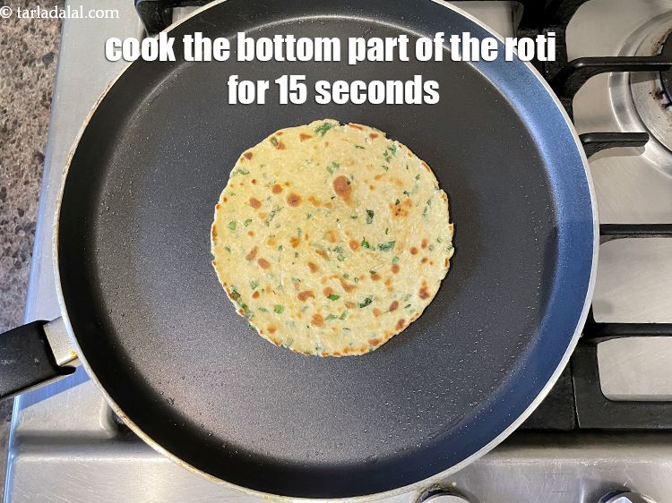Step 22 – <meta charset="UTF-8" />Cook the bottom part of the roti for 15 seconds&nbsp;and grease the top …
