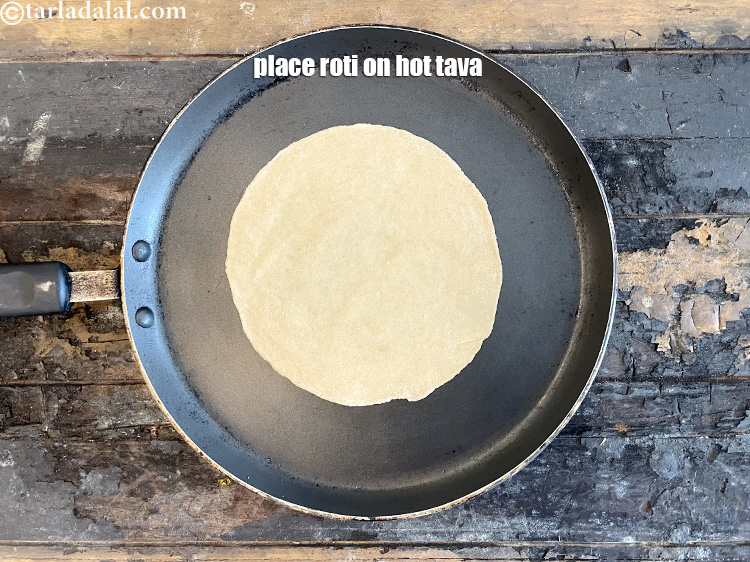 Step 22 – <meta charset="UTF-8" /> Place roti on hot greased tava.&nbsp;&nbsp;