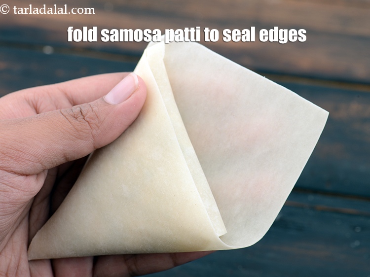 Step 21 – Fold the samosa patti like shown in the image to seal the edges.
