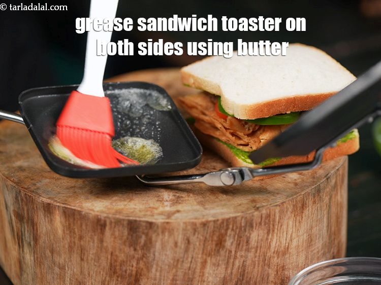 Step 23 – Grease a sandwich toaster on both the sides using 1 tsp of &nbsp;<a href="https://www.tarladalal.com/glossary-butter-makhan-233i">butter</a>.