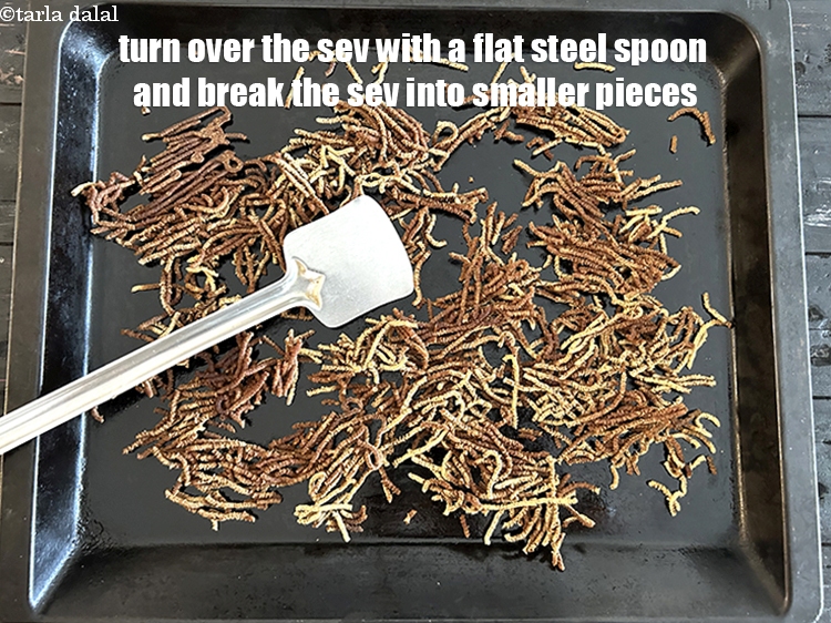 Step 30 – Turn over the sev with a flat steel spoon. Break the sev into smaller pieces.