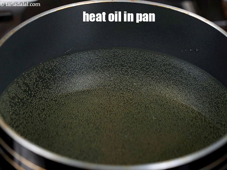Step 22 – Heat the <a href="https://www.tarladalal.com/glossary-oil-671i">oil</a>&nbsp;in a deep non-stick pan.&nbsp;