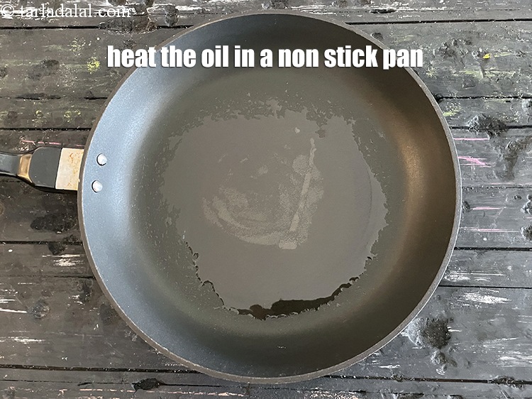 Step 46 – Heat 2 tablespoons oil in a broad non-stick pan.