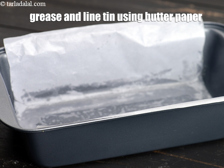 Step 3 – To make <strong>chocolate walnut cake</strong>, grease and line the tin using butter paper.