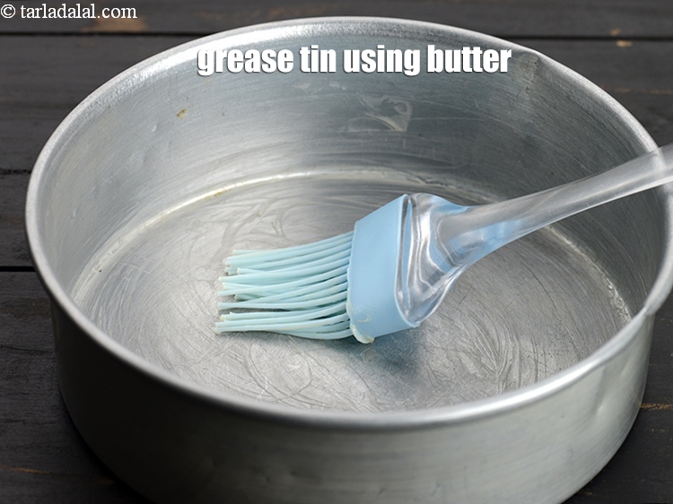 Step 5 – To make <strong>eggless vanilla cake</strong>, grease the tin using little butter.
