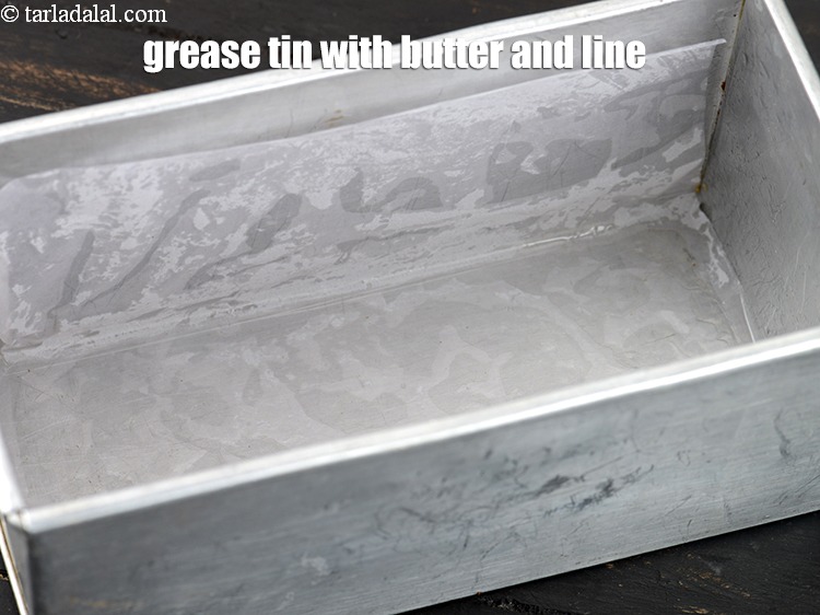 Step 3 – To make <strong>oreo biscuit cake</strong>, grease the tin with butter and line with butter paper.