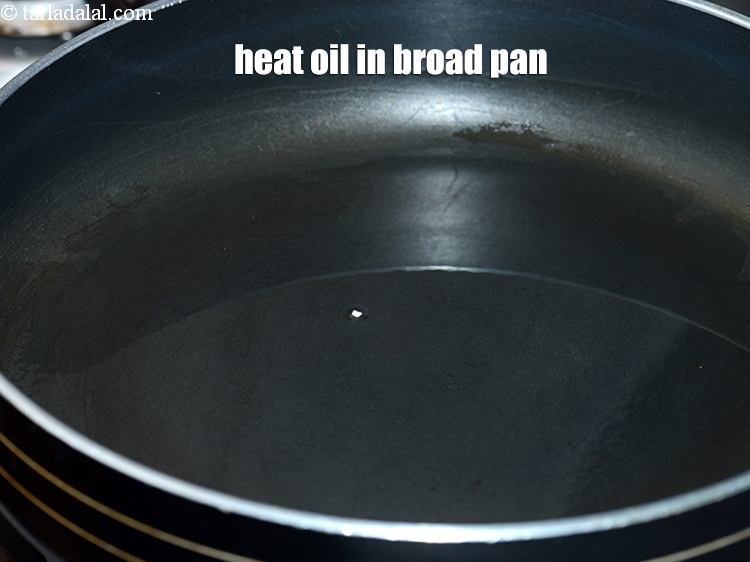 Step 3 – To make <strong>rajgira chivda</strong>, heat 2 tbsp oil in a broad non-stick pan.