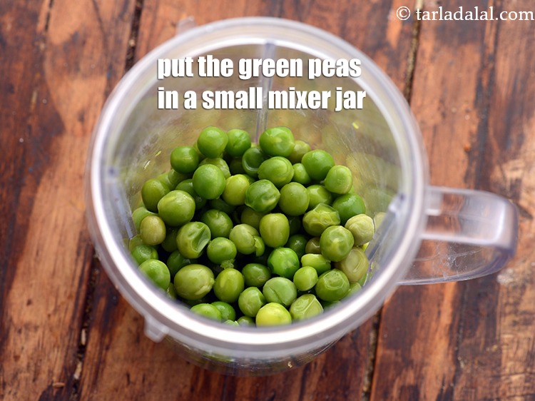 Step 2 – To make the <strong>green pea chutney recipe</strong>, put the green peas in a small mixer …