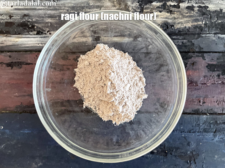 Step 3 – In a bowl put&nbsp;<!--%3Cmeta%20charset%3D%22UTF-8%22%20%2F%3E-->1/2 cup&nbsp;<a href="glossary-ragi-flour-nachni-flour-nachni-ka-atta-red-millet-flour-1115i">ragi (nachni / red millet) flour</a>.