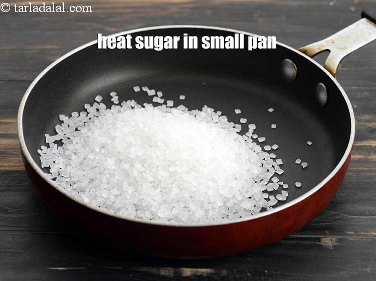 Step 3 – To make <strong>eggless caramel custard</strong>, heat &frac14; cup <a href="https://www.tarladalal.com/glossary-sugar-chini-shakkar-278i">sugar</a> in a small non-stick pan.