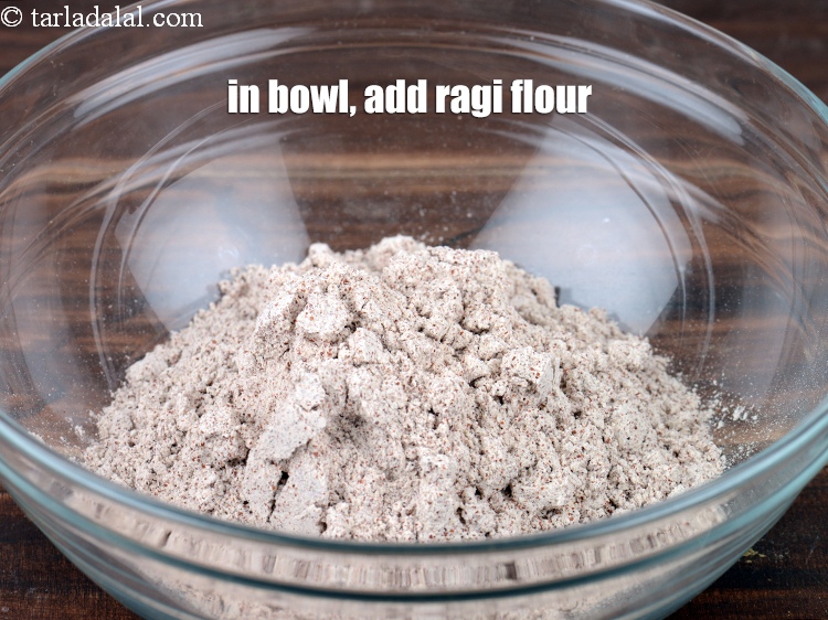 Step 3 – In a deep bowl, &frac12; cup <a href="https://www.tarladalal.com/glossary-ragi-flour-nachni-flour-nachni-ka-atta-red-millet-flour-1115i">ragi (nachni / red millet) flour</a>.