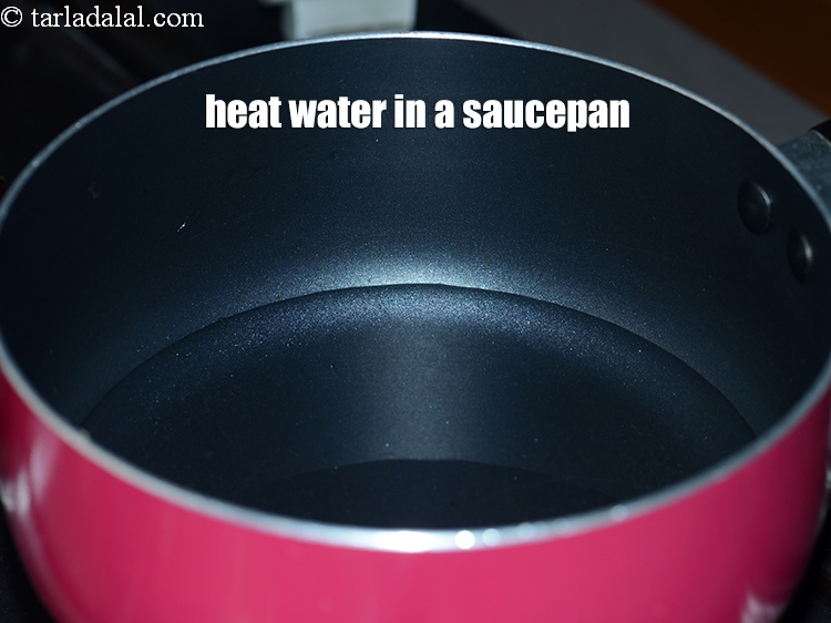 Step 4 – To make <strong>Gujarati style gathiya</strong>, heat &frac12; cup of water in a saucepan.