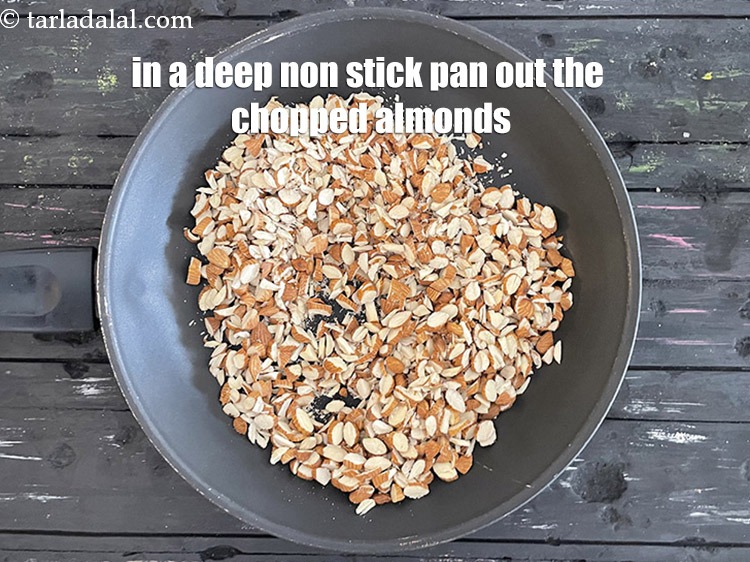 Step 11 – In a deep non stick pan put&nbsp;1 cup&nbsp;<a href="https://tarladalal.com/glossary-chopped-almonds-865i">chopped almonds (badam)</a>.